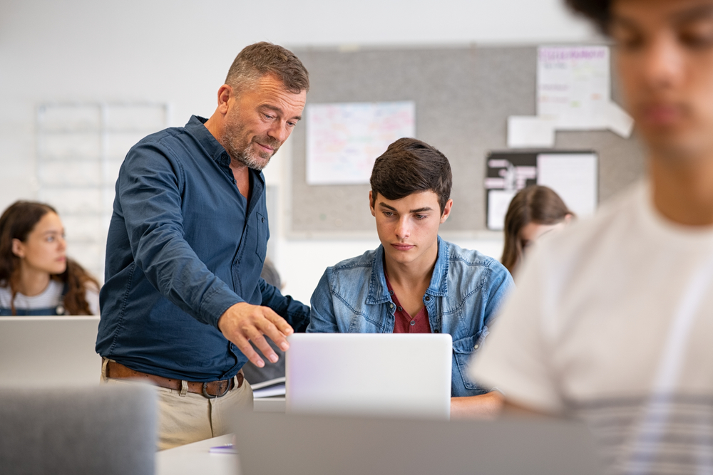 Photo of Professor Assisting A Student